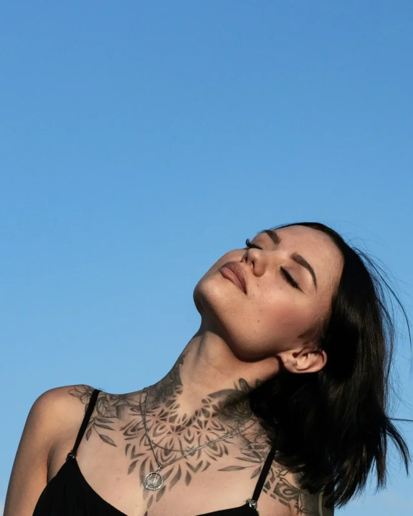 woman with intricate mandala tattoo on Neck