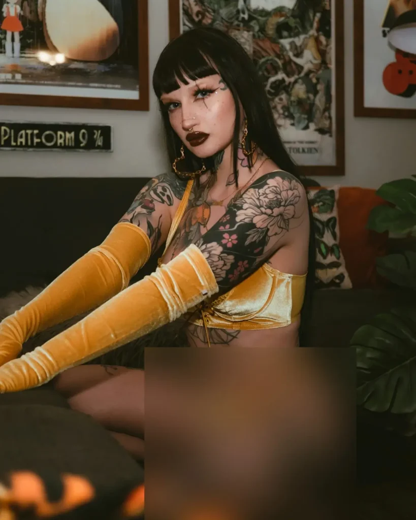 woman with sun and moon tattoo on upper arm