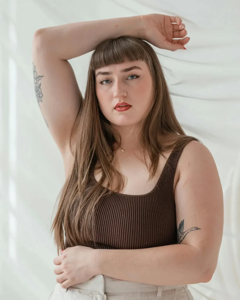 young woman smiling confidently in soft sunlight