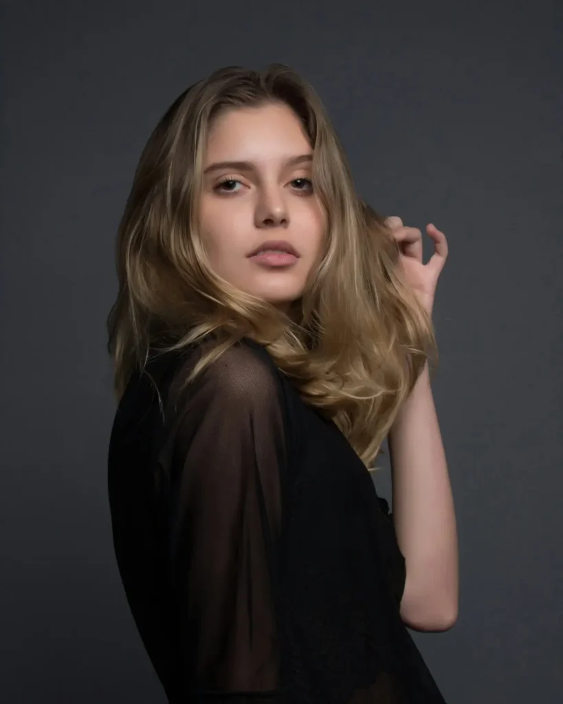 woman laughing confidently in open field