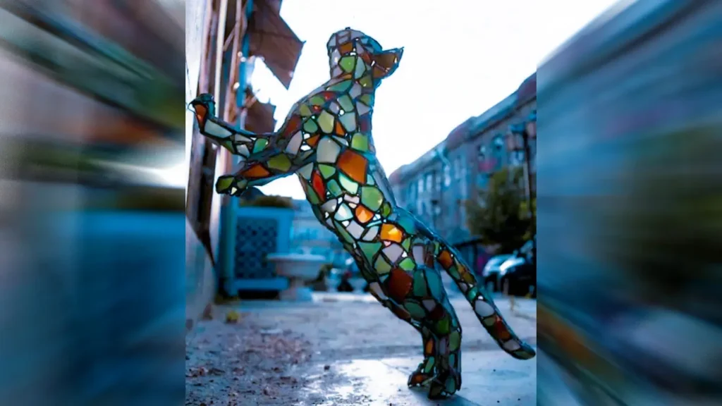 Crafted from hundreds of tiny pieces of broken stained glass cat